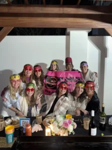 Guests enjoying a private outdoor hibachi dinner by My Hibachi 30A with chef and festive headbands
