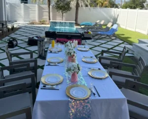 Backyard hibachi table setup in Florida with poolside catering, fresh plates, and festive decor